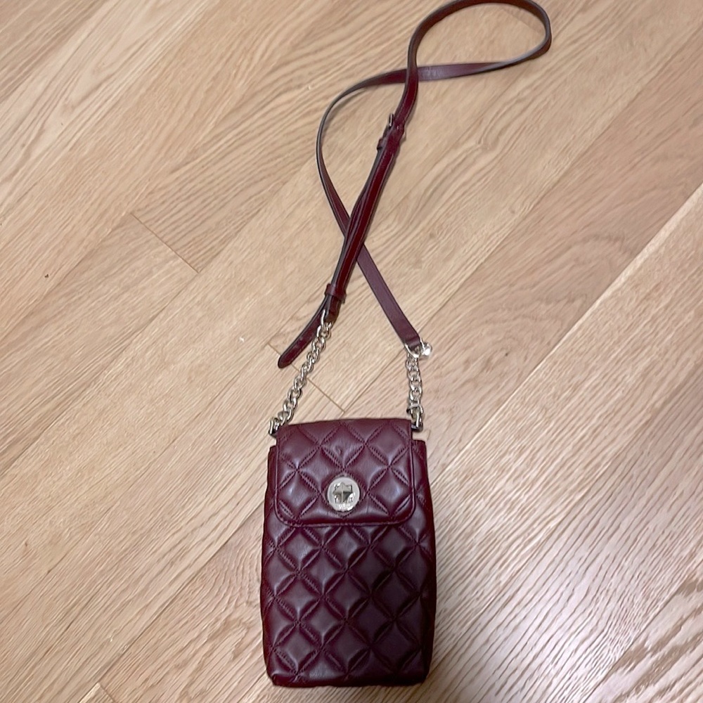 Brand new Kate Spade maroon crossbody/shoulder clutch w/gold accents.